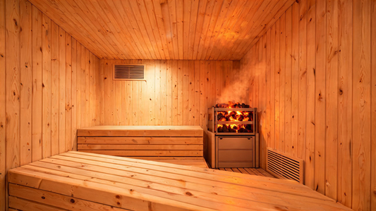 A beautifully constructed home sauna interior in Grade-A Canadian cedar, viewed from the bench level looking toward the…
