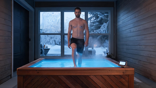 A composed adult stepping calmly into a sleek modern cold plunge in a tidy garage at pre-dawn in a Canadian winter