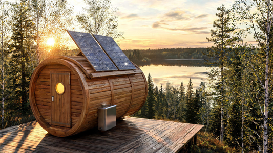 A compact cedar barrel sauna sitting on a remote lakeside deck at golden hour, two frameless photovoltaic panels mounted flush on the sloped roof catching