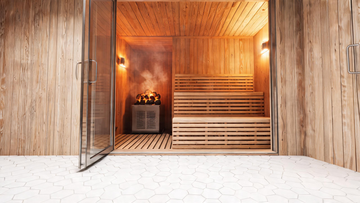 A warm cedar-lined sauna interior tucked inside a renovated bathroom, tempered glass door slightly ajar showing two-level…